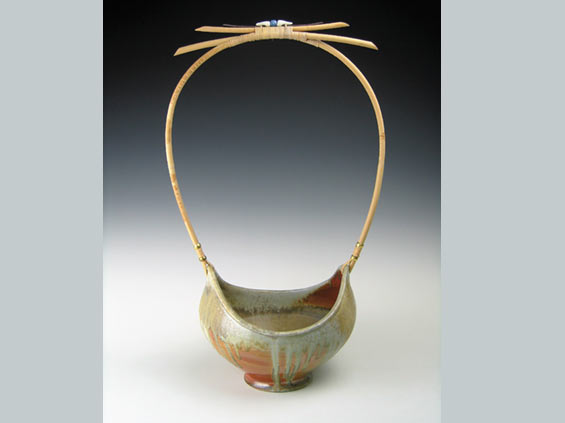 Basket, with cane and reed handle